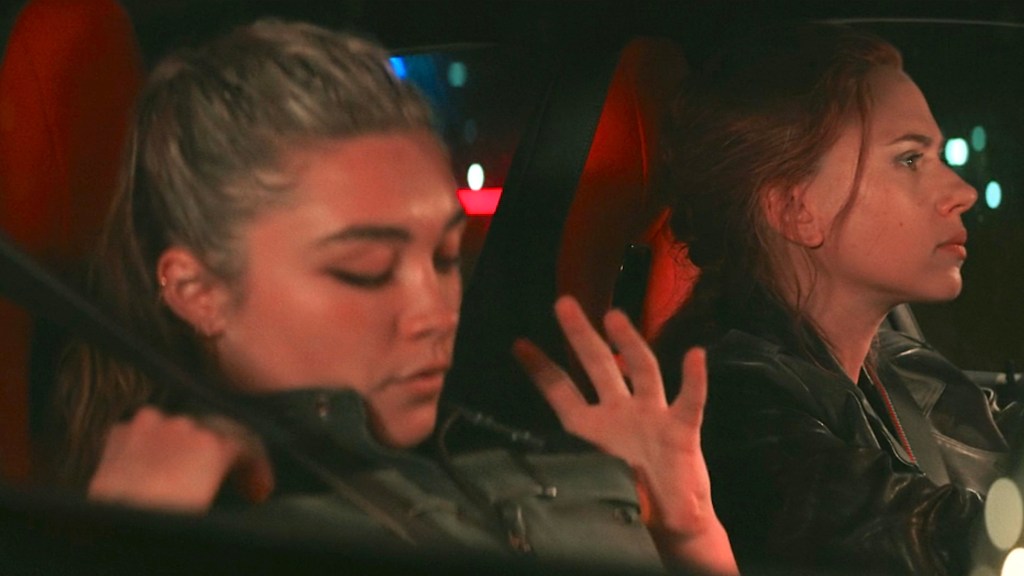 Yelena admires her green vest while in the car with Natasha
